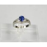 A 14ct white gold, sapphire and diamond ring, the sapphire approximately 1ct, the diamonds totalling