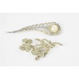 A feather form brooch with pearl embellishment, an orchid form brooch set with marcasite, 7cm high.