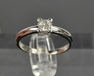 A platinum and diamond ring, set with four princess cut diamonds totalling 0.25cts, size O½, 4.4g. - Image 5 of 5