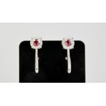 An 18ct white gold, ruby and diamond earrings, the rubies totalling approximately 0.3ct, the