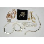 A group of silver jewellery, including necklaces, heart form pendant, and rose gold colour necklace.