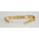 A 9ct gold bracelet with heart form clasp and safety chain, the links of gate form, 8.5g.