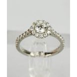 A platinum and diamond 'halo' cluster ring, the central diamond approximately 0.50cts, and a