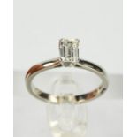 A platinum, and diamond ring, the emerald cut diamonds approximately 0.72ct, size M, 4.2g.