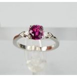 An 18ct white gold, pink sapphire and diamond ring, the sapphire approximately 1ct, the diamonds 0.