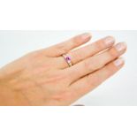 A 14ct white gold, pink sapphire, and diamond ring, the sapphire approximately 0.5ct, the diamonds