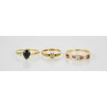 Three 9ct gold rings, one set with four pink rubies and diamonds, size R, 5.6g