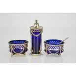 A Dutch silver pair of salts and similar pepper, all with blue glass liners, the salts decorated