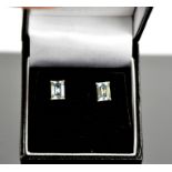 A pair of 9ct yellow gold and aquamarine stud earrings, each set with cushion cut 1ct aquamarines.