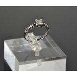 A platinum and diamond ring, set with four princess cut diamonds totalling 0.25cts, size O½, 4.4g.