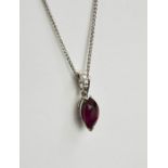 An 18ct white gold, ruby and diamond pendant and chain, the ruby 2ct, the diamonds set to the