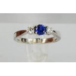 An 18ct white gold, sapphire and diamond trilogy ring, size M, 4.4g.