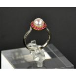 A platinum, rose gold, pearl and pink ruby ring, size N/O, 4.1g..