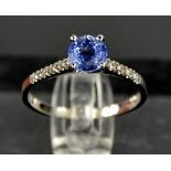 A 14ct white gold, blue sapphire and diamond ring, size M, 1.8g.