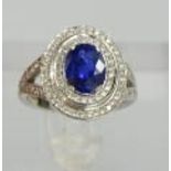 An 18ct white gold and sapphire ring, the sapphire approximately 2ct, bordered by two rows of