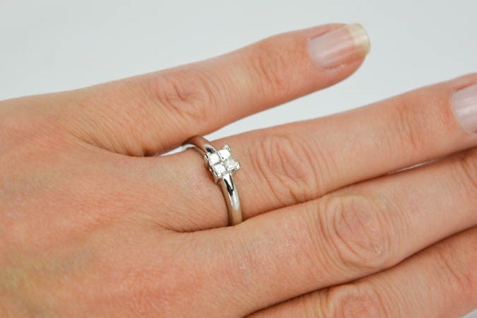 A platinum and diamond ring, set with four princess cut diamonds totalling 0.25cts, size O½, 4.4g. - Image 3 of 5