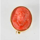 A 19th century coral cameo and 15ct gold brooch modelled in high relief, in plain gold oval setting,