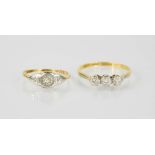 An 18ct gold, platinum and diamond three stone ring, size I/J, and an 18ct gold ring set with