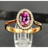 An 18ct rose gold, pink sapphire and diamond ring, approximately 1ct sapphire bordered by