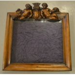A Victorian walnut wall display case, with twin cherub crest surmount, the interior lined in