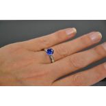 An 18ct white gold, blue sapphire and diamond ring, the sapphire approximately 0.7g, the diamonds