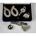 A group of jewellery, to include locket and key pendant, diamante heart pendant necklace, a pair