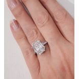 A platinum and diamond ring, the emerald cut central diamond 2.23ct, and the baguette cut