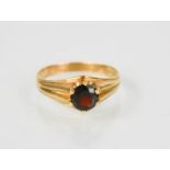 A 9ct gold and garnet solitaire ring, size T, 3.1g.