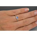 A 9ct white gold, sapphire and diamond 'halo' cluster ring, size M, 1.7g.
