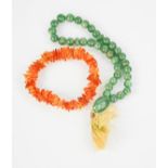 A jade beaded necklace with tassel, together with a clear amber bracelet.