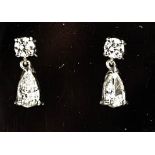 An 18ct white gold and diamond pear drop earrings, the two pear drops totalling 1ct, with two