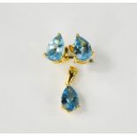An 18ct white gold and blue topaz pear shaped earrings and pendant, 2.5g.