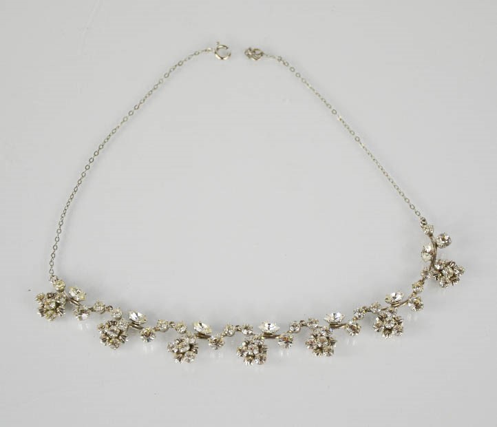 A 1930s paste / diamante necklace, composed of flowerheads, 41cm long.