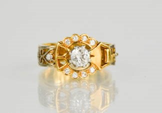 An 18ct gold buckle ring, centred by a diamond approximately 0.75cts and set with twelve further