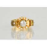 An 18ct gold buckle ring, centred by a diamond approximately 0.75cts and set with twelve further