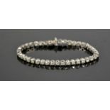 An 18ct white gold and diamond tennis bracelet, the diamonds totalling 5.10cts, 13.1g.