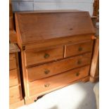 A pine bureau with fall front and fitted interior, with two short over two long drawers. 95cm high x