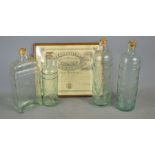 Four wine / brandy bottles with decorated front together with a framed certificate for hedge