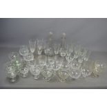 Two vintage glass decanters and a large quantity of crystal glasses