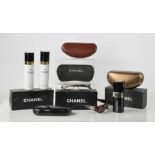 A group of Chanel boxes, a Chanel sunglasses case, Chanel spectacles, Gucci glasses case and