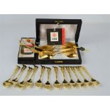 A boxed set of six gold plated spoons by Solingen together with a boxed Solingen gold plated sugar