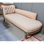 A Victorian chaise longue, with floral button back upholstery.