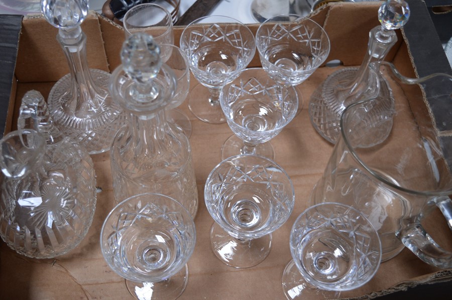 A quantity of crystal and glassware to include three decanters, large jug, and glasses.