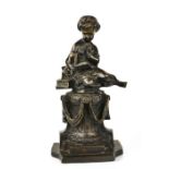 A late 19th century bronze figure of a lady reading a book.