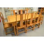 A Chinese dining table and set of matching chairs.