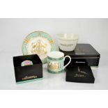 A group of Fortnum & Mason collectables including cup and saucer, and tea caddy form decoration.