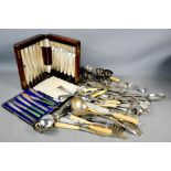 A group of silverplate ware, including boxed flatware, egg cups and other cutlery.