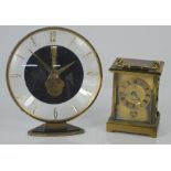 A Vintage Cyma brass carriage clock together with a Estyma 7 jewel, 8 day clock