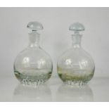 A pair of glass decanters.