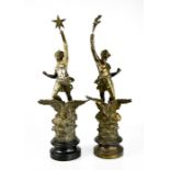 A pair of spelter 19th century figures with eagles at their feet, raised on socle bases.